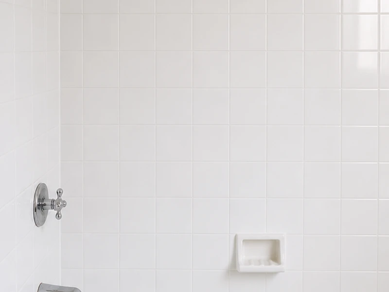 The same San Francisco bathroom tile wall after reglazing, recolored to a clean glossy white with crisp grout lines